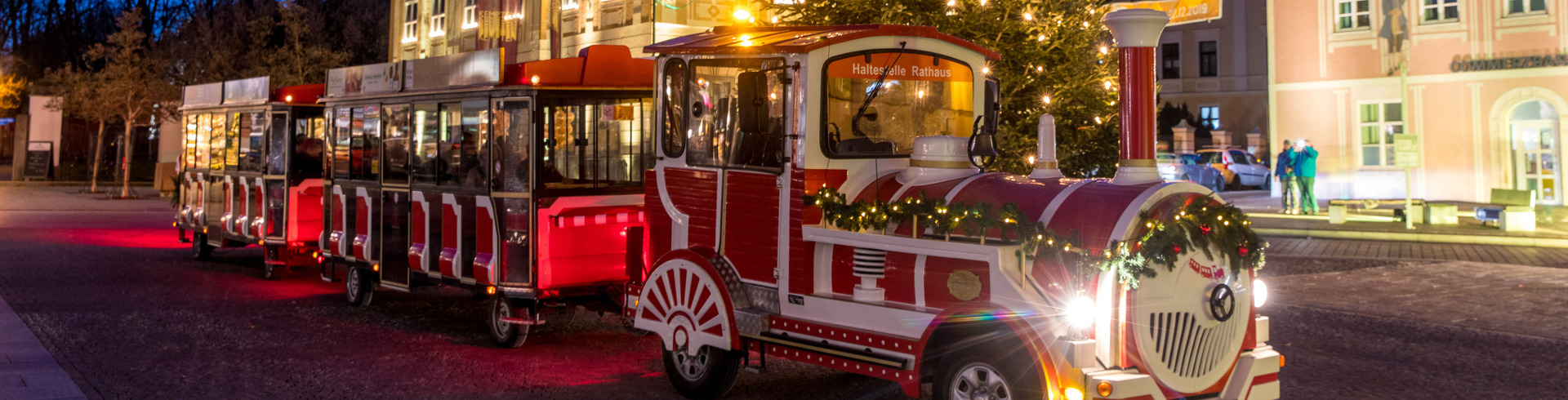 The Chrismas train in front of a christmas tree