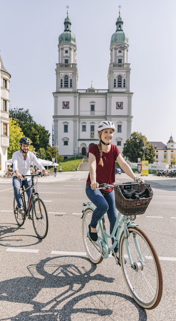 Cyclists in front of the Basilica of St Lorenz