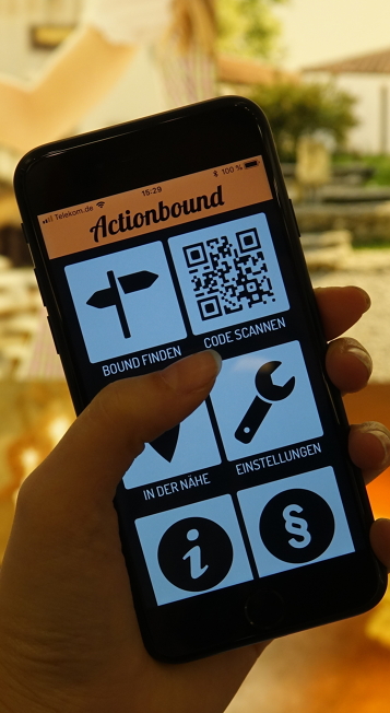 A mobile phone shows the open Actionbound app